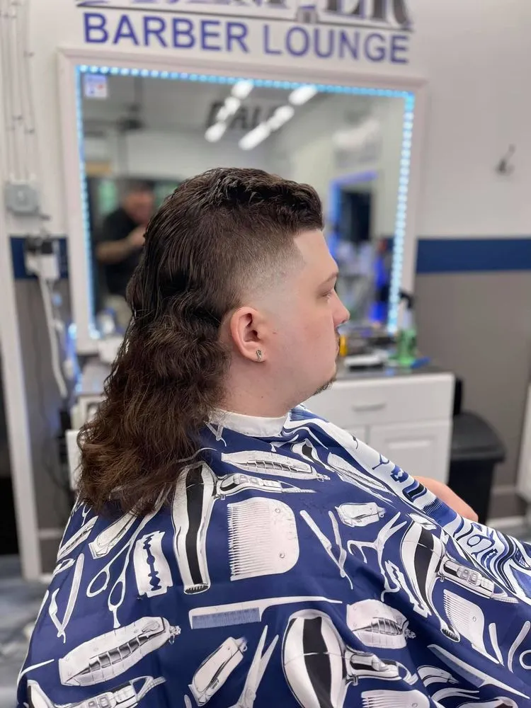 Mullet with faded sides styled at Parma Premier Barber Lounge.