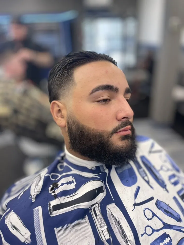 Client with textured curls and fade at Parma barbershop.