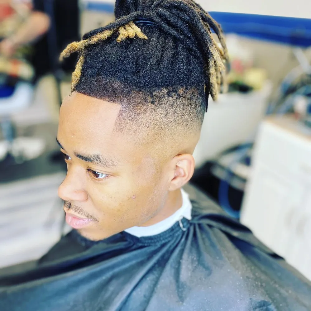 Dreadlocks with high skin fade and sharp lineup.