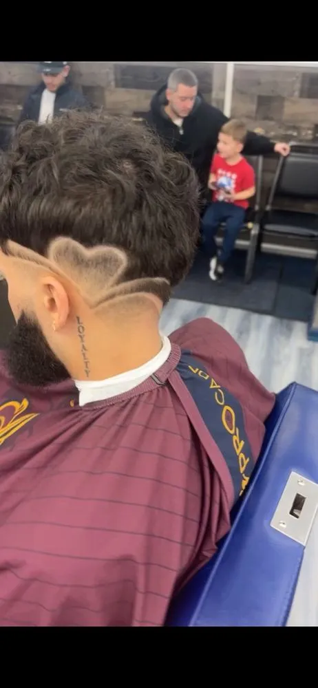 Heart design shaved into back of head with fade.